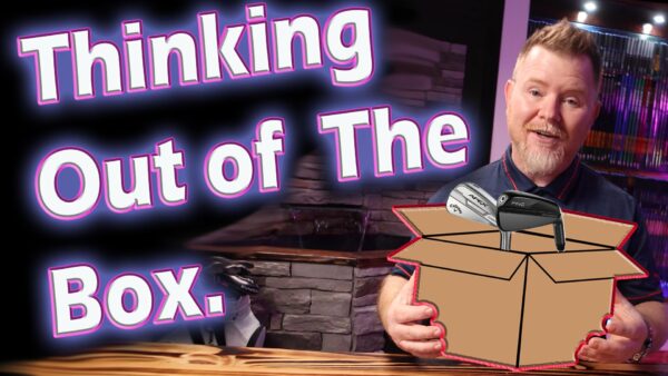 A man stands indoors holding a box with golf clubs inside. Large text beside him reads "Thinking Out of The Box.